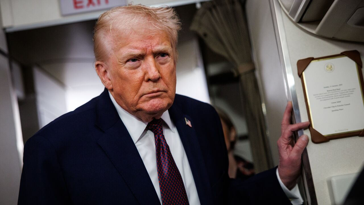 US President Donald Trump takes questions from the members of the press aboard Air Force One on Jan. 11, 2026, en route back to the White House from Palm Beach, Florida. 