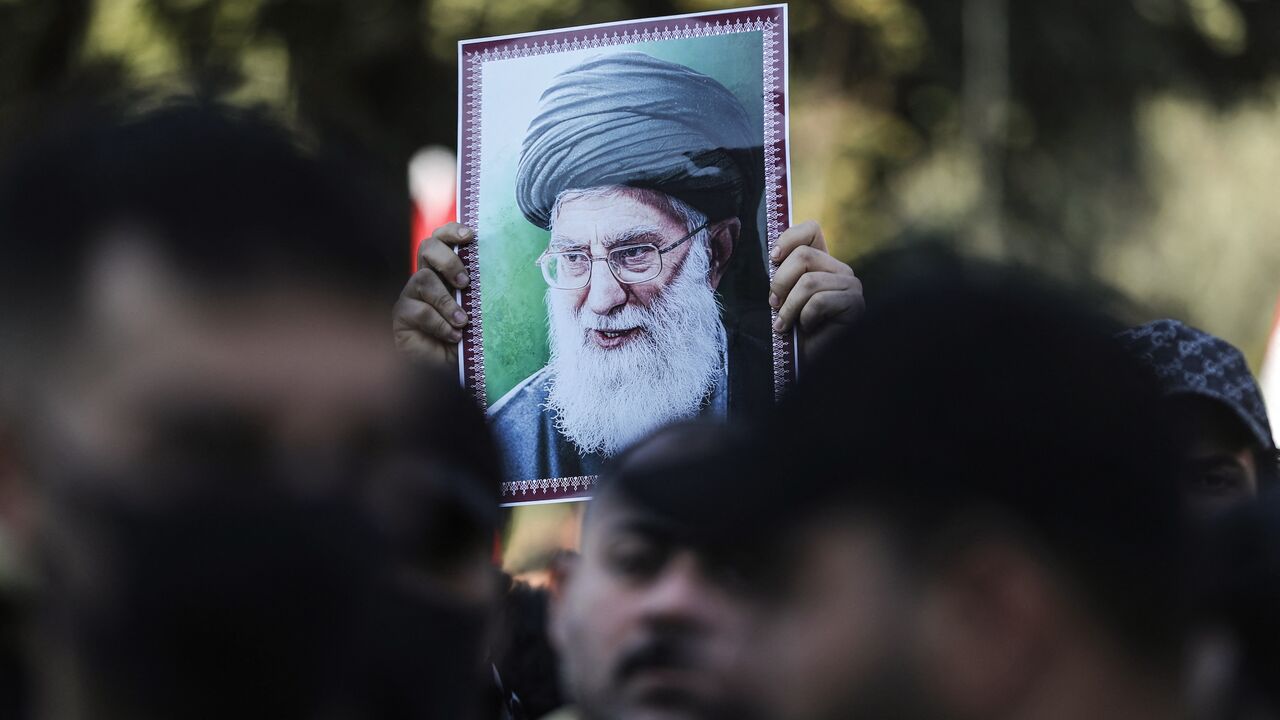 A protester holds up a portrait of Iran's Supreme Leader Ayatollah Ali Khamenei during a demonstration near the Iranian Embassy in Baghdad, on Jan. 16, 2026.