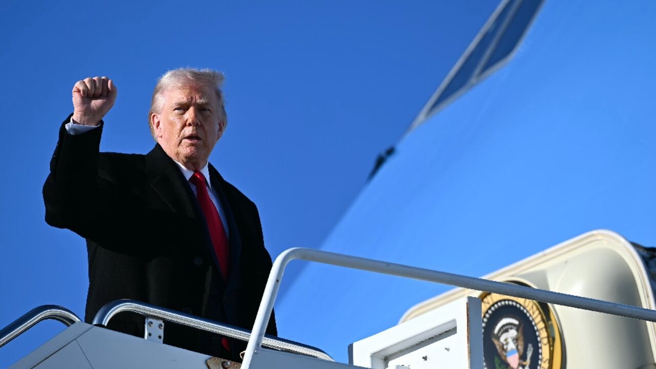 US President Donald Trump gestures as he boards Air Force One at Fort Bragg, North Carolina