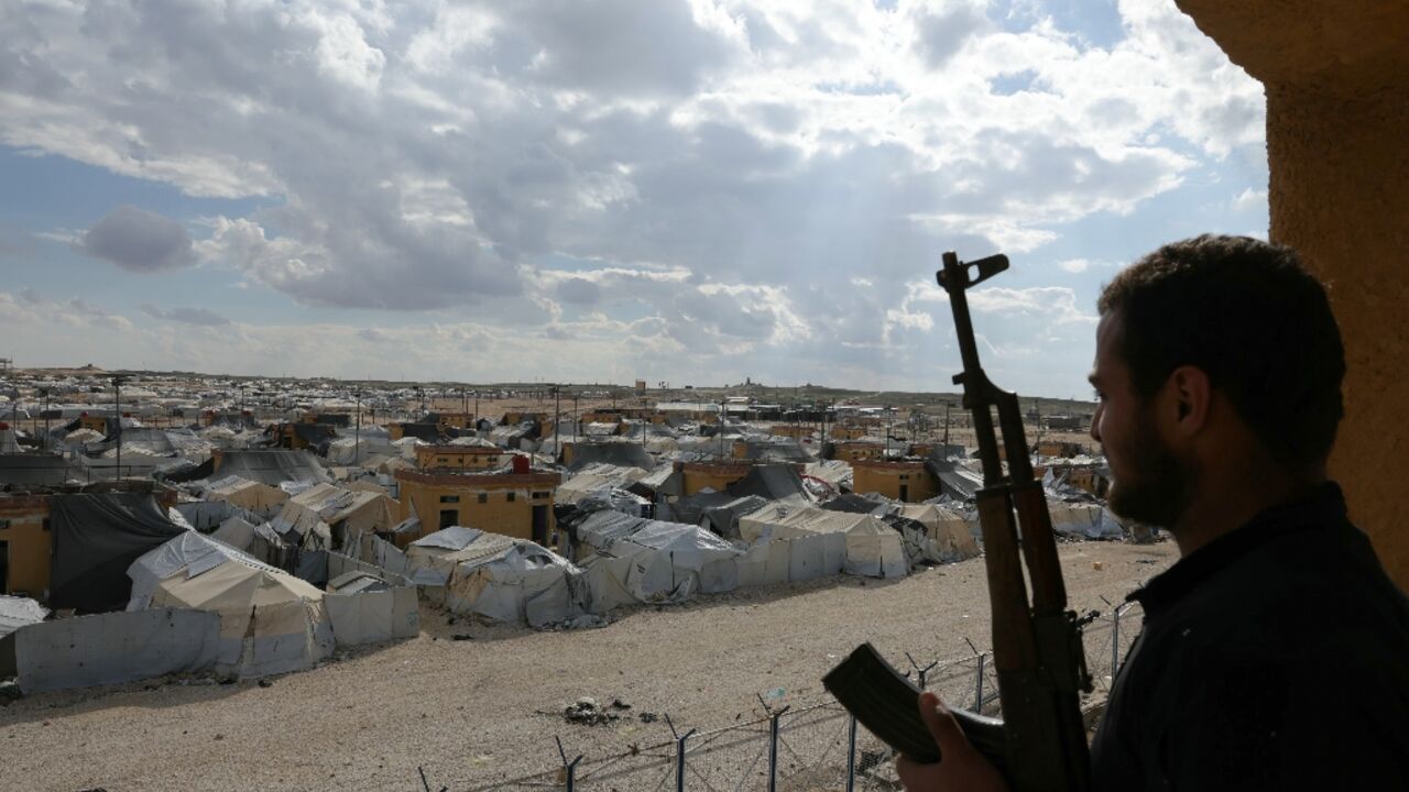 A Syrian troop looks out over the Al-Hol camp, where thousands of family members of suspected IS jihadists left last month