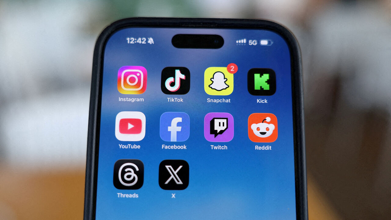 FILE PHOTO: Instagram, TikTok, Snapchat, Kick, YouTube, Facebook, Twitch, Reddit, Threads and X applications are displayed on a mobile phone in this picture illustration taken on December 9, 2025. REUTERS/Hollie Adams/Illustration/File Photo