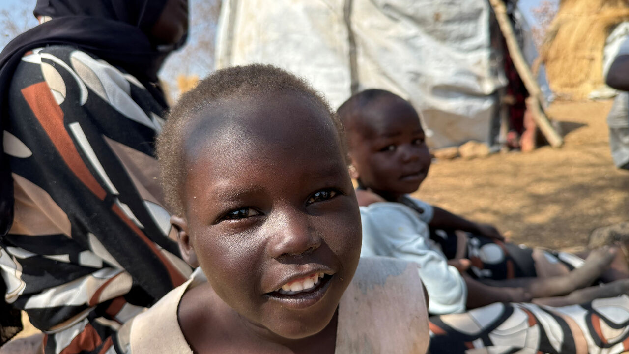 A boy reacts as he sits with his family, displaced from Kadugli, at Embal Camp in Engpung County, Sudan, January 30, 2026. Karl Schembri/Norweigan Refugee Council/Handout via REUTERS    THIS IMAGE HAS BEEN SUPPLIED BY A THIRD PARTY.