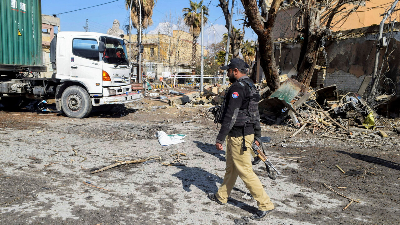 FILE PHOTO: A police officer walks past damage at the site, after militant attacks, in Quetta, Pakistan, February 1, 2026. REUTERS/Stringer/File Photo