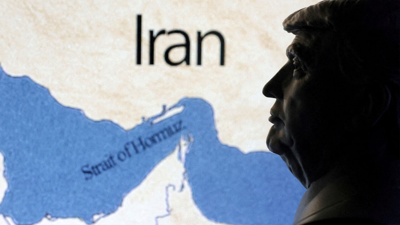 FILE PHOTO: A map showig the Strait of Hormuz and Iran is seen behind a 3D printed miniature of U.S. President Donald Trump in this illustration taken June 22, 2025. REUTERS/Dado Ruvic/Illustration/File Photo