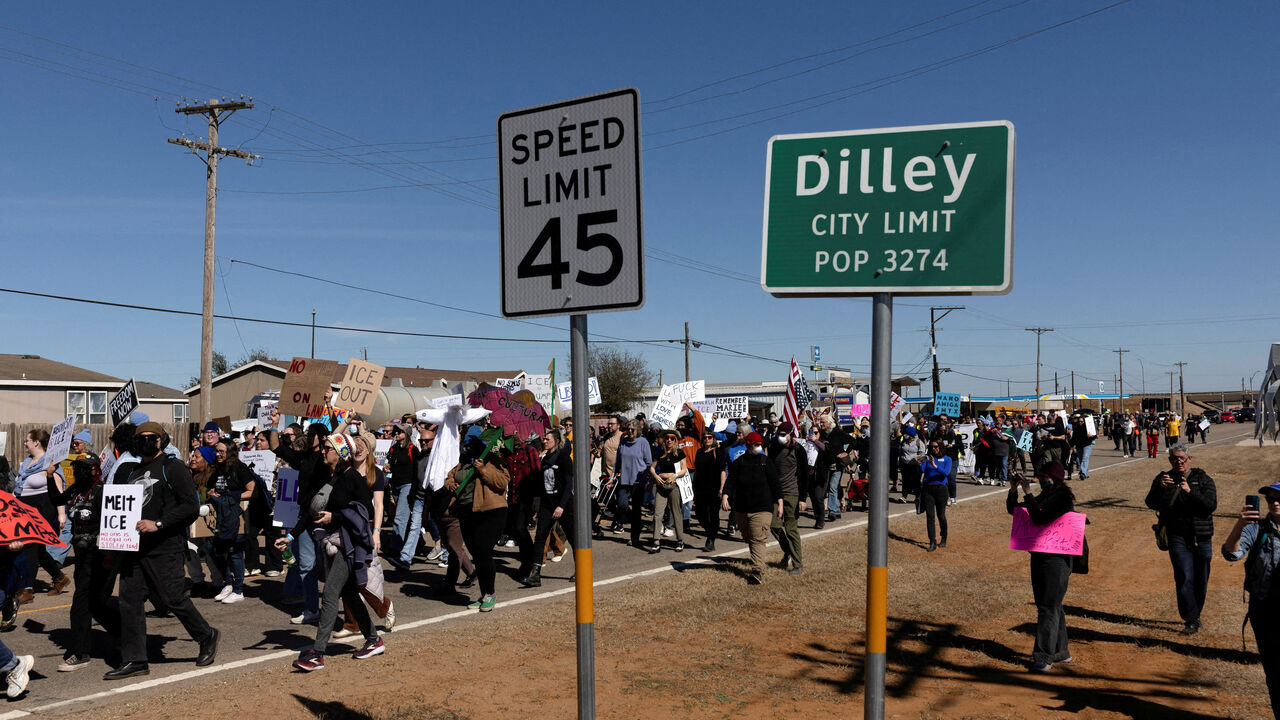 FILE PHOTO: People march to take part in a protest at the South Texas Family Residential Center in Dilley, Texas, U.S., January 28, 2026.  REUTERS/Antranik Tavitian//File Photo