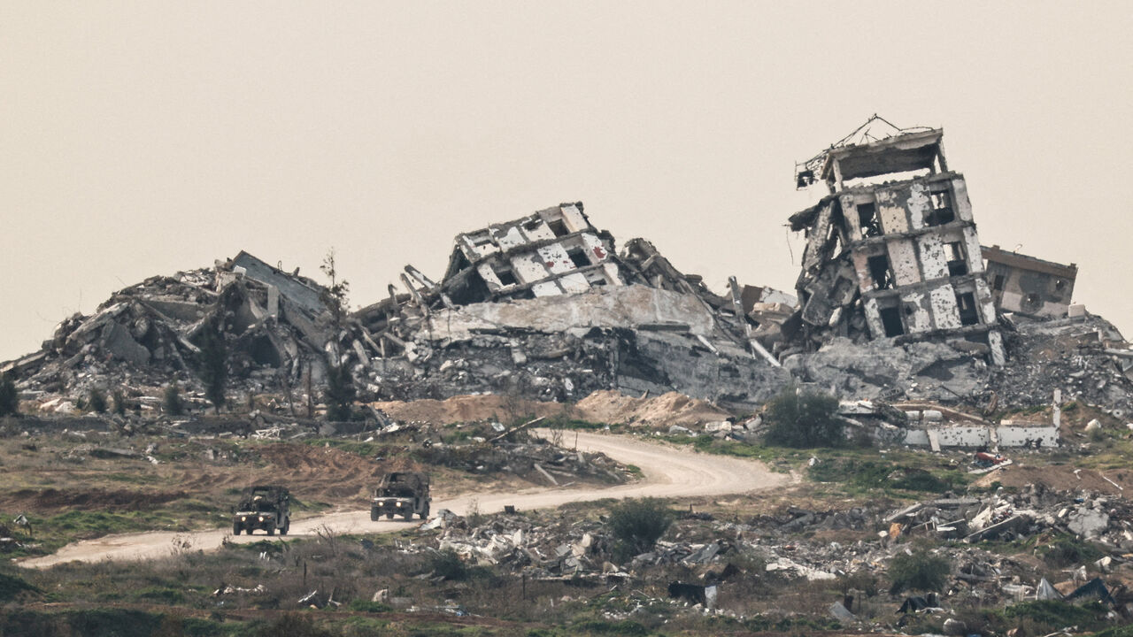 FILE PHOTO: Israeli military vehicles drive past destruction in Gaza, as seen from the Israeli side of the Israel-Gaza border in southern Israel, January 21, 2026. REUTERS/Amir Cohen/File Photo