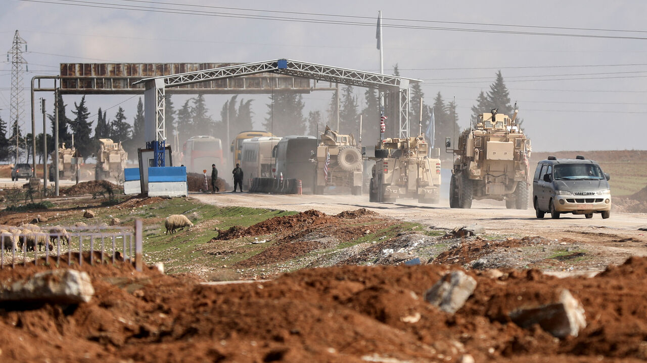 U.S. military vehicles escort buses transporting Islamic State detainees from Syria to Iraq, according to a security source from the Syrian Democratic Forces, in Qamishli, Syria, February 8, 2026. REUTERS/Orhan Qereman