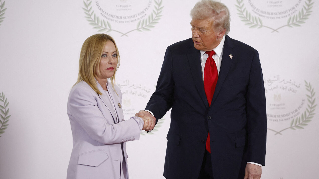 FILE PHOTO: U.S. President Donald Trump and Italian Prime Minister Giorgia Meloni shake hands as they pose for a photo, at a world leaders' summit on ending the Gaza war, amid a U.S.-brokered prisoner-hostage swap and ceasefire deal between Israel and Hamas, in Sharm el-Sheikh, Egypt, October 13, 2025. Yoan Valat/Pool via REUTERS/File Photo