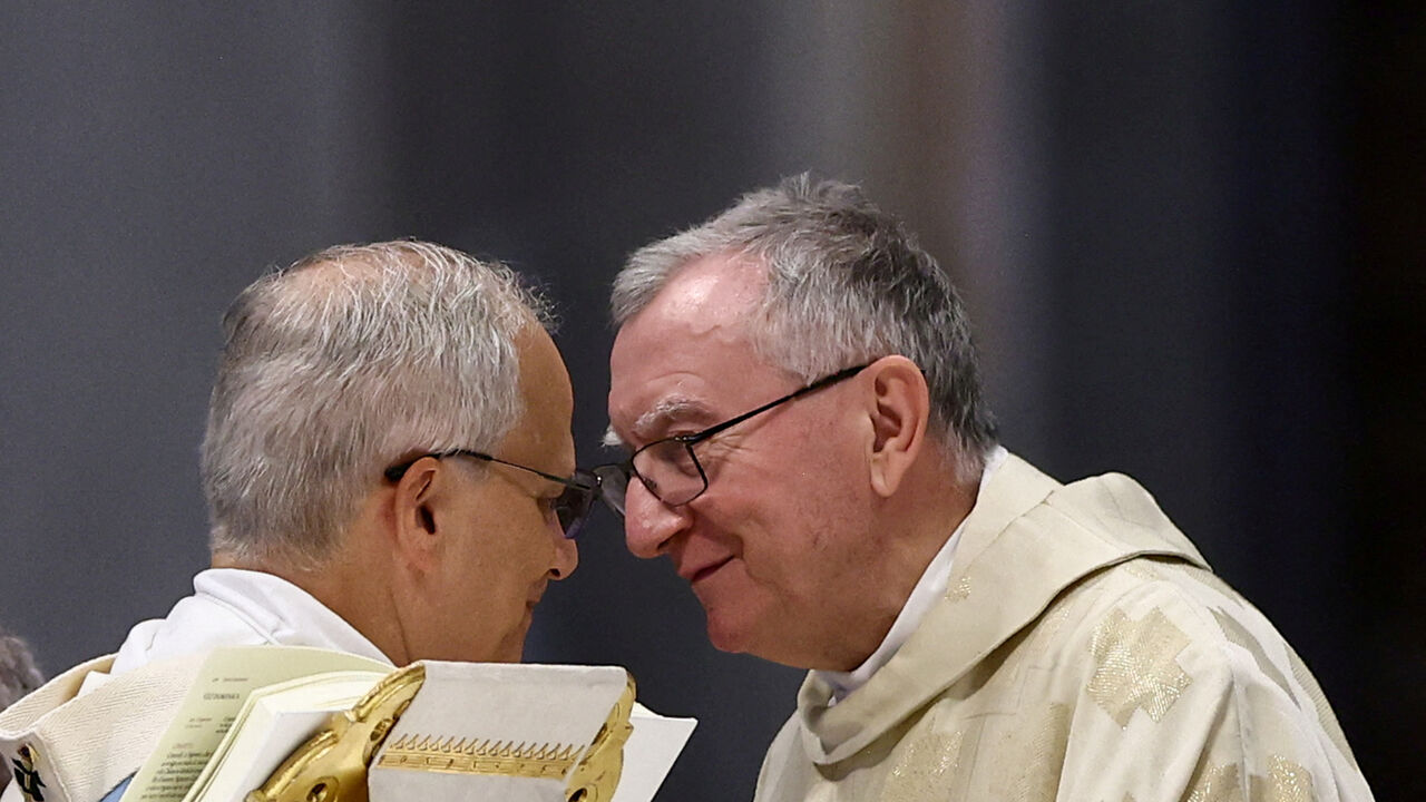 FILE PHOTO: Pope Leo XIV speaks with Vatican Secretary of State Cardinal Pietro Parolin during the Mass for the Holy See Jubilee, in St. Peter's Basilica, at the Vatican, June 9, 2025. REUTERS/Yara Nardi/File Photo