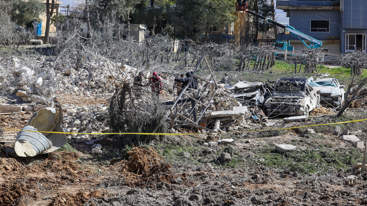 People inspect the damage at the site of an Israeli strike on Friday, in Bednayel, Bekaa valley, Lebanon, February 21, 2026. REUTERS/Mohamed Azakir