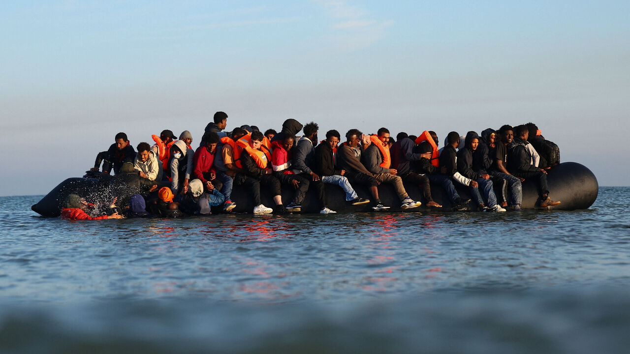 A group of migrants on an inflatable dinghy leave the beach of Petit-Fort-Philippe in northern France in an attempt to cross the English Channel to reach Britain, in Gravelines, near Calais, France, September 27, 2025. REUTERS/Abdul Saboor/File Photo