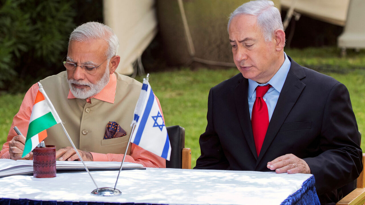 FILE PHOTO: Indian Prime Minister Narendra Modi (L) and Israeli Prime Minister Benjamin Netanyahu (R) sign the guest book at the Indian Army Cemetery of World War I to honour fallen Indian soldiers, in the Israeli coastal city of Haifa July 6, 2017. REUTERS/Jack Guez/Pool/File Photo