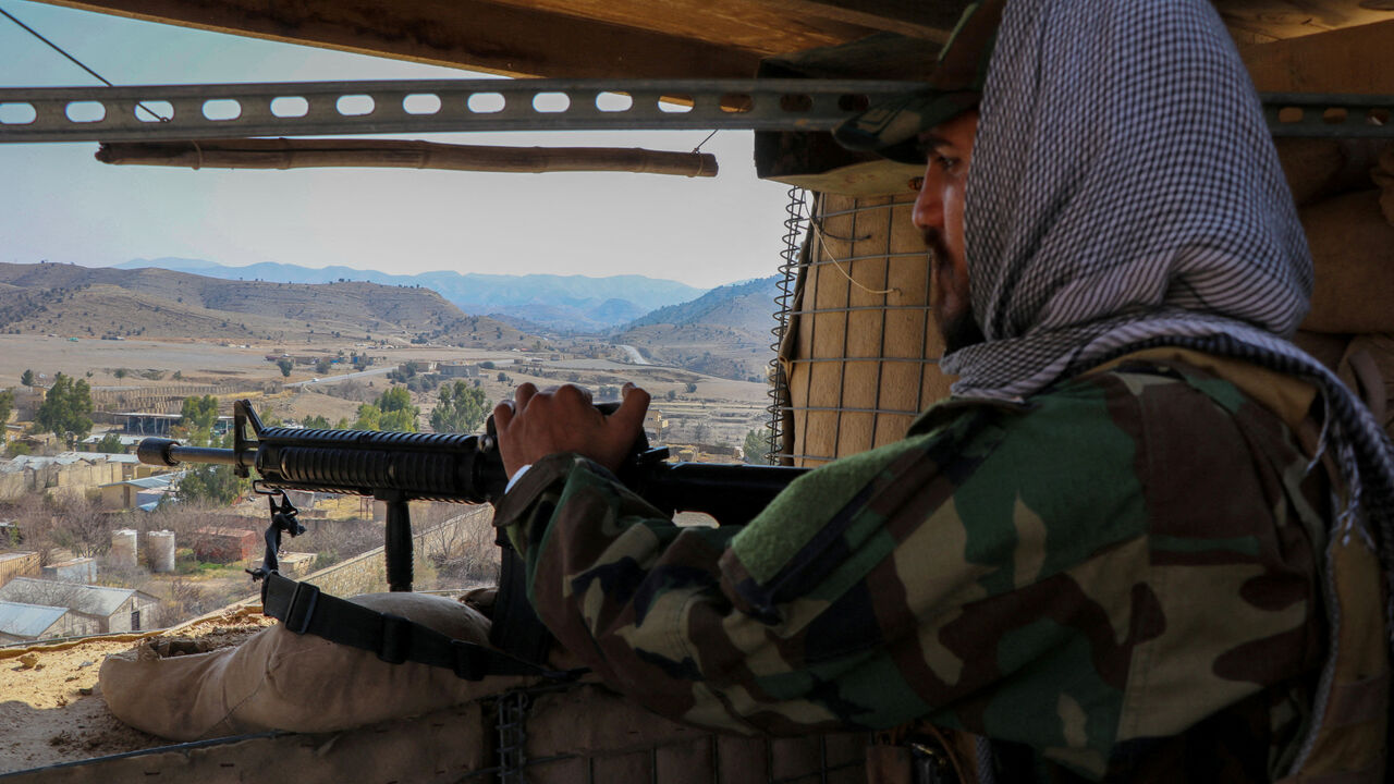 FILE PHOTO: A Taliban soldier keeps vigil from inside his post near the Pakistan-Afghanistan border, in Khost province, Afghanistan, February 27, 2026. REUTERS/Stringer/File Photo