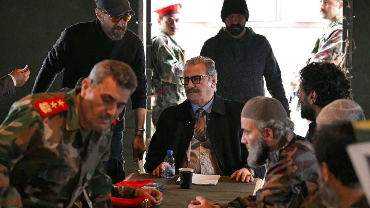 Jordanian director Mohammed Lutfi (top L) instructs actors on set during the filming of the Arabic TV Series 'Al-Khuruj min al-Beir" (Exiting the Well) in Zouk Mikhael, north of Beirut, on February 17, 2026