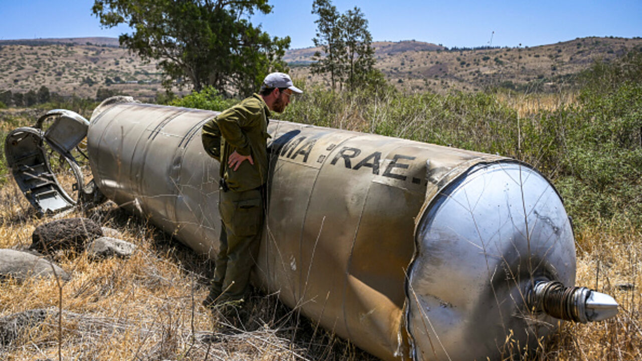 Members of the Israeli security forces check the apparent remains of an Iranian ballistic missile lying on the ground in the Golan Heights, Northern Israel, on Thursday, June 19, 2025. (Photo by Michael Giladi / Middle East Images via AFP) (Photo by MICHAEL GILADI/Middle East Images/AFP via Getty Images)
