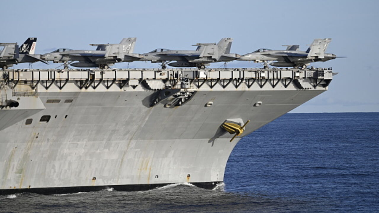 DENMARK-NORWAY-US-FRANCE-NATO-ARMY-DEFENCE-EXERCISE Picture taken on September 24, 2025 from the French Navy frigate Bretagne shows F-18 fighter jets on the deck of the the world's largest aircraft carrier USS Gerald R Ford as both ships are taking part in the NATO Neptune Strike 2025 exercise in the North Sea. According to NATO, more than 10,000 sailors, soldiers, aviators and marines from 13 allied nations took part in the large-scale multinational enhanced Vigilance Activity, running from September 22 to