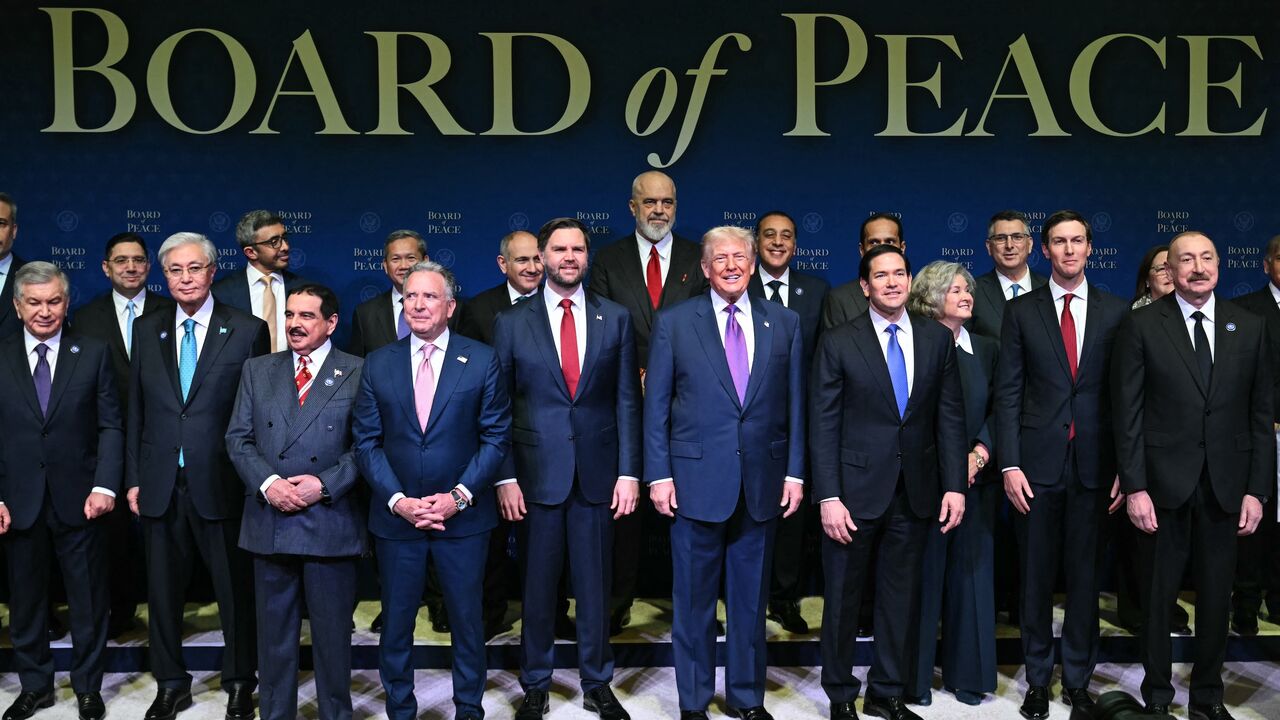 US President Donald Trump (C), flanked by US Vice President JD Vance (L) and US Secretary of State Marco Rubio (R), joins leaders for a group photo during the inaugural meeting of the Board of Peace at the US Institute of Peace in Washington, on Feb. 19, 2026.