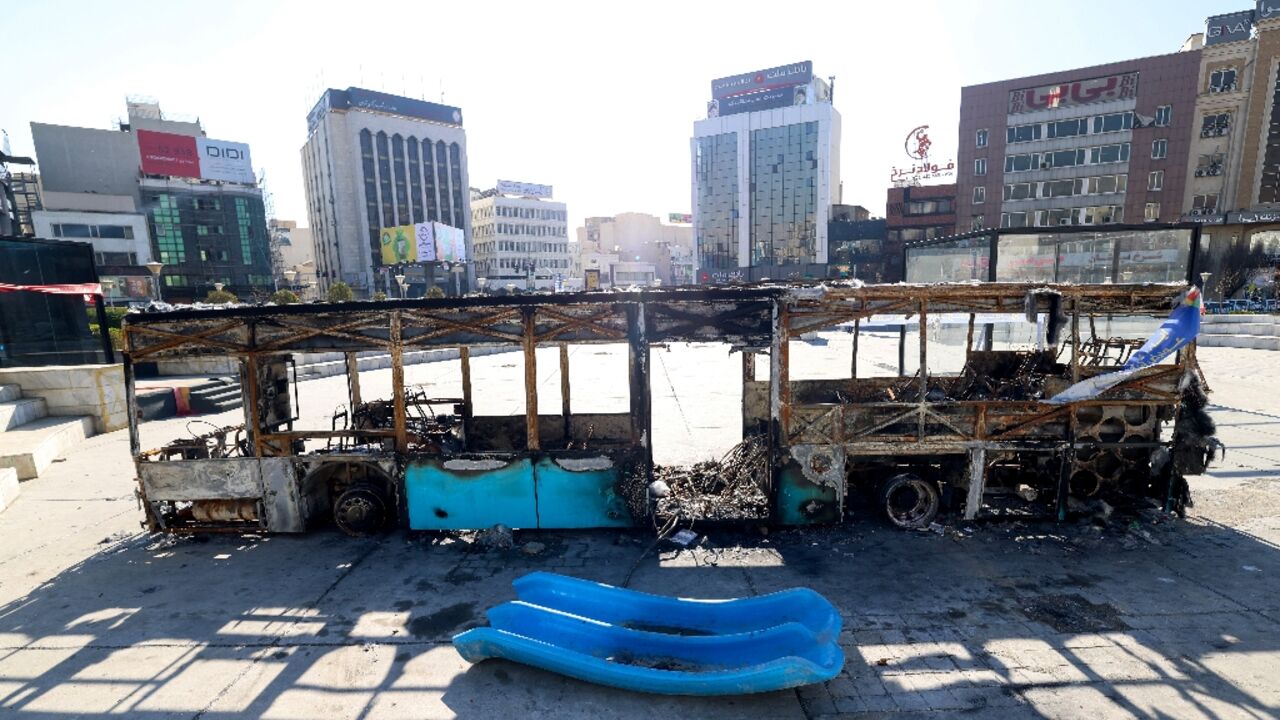 A destroyed bus in Tehran's Haftome-tir Square