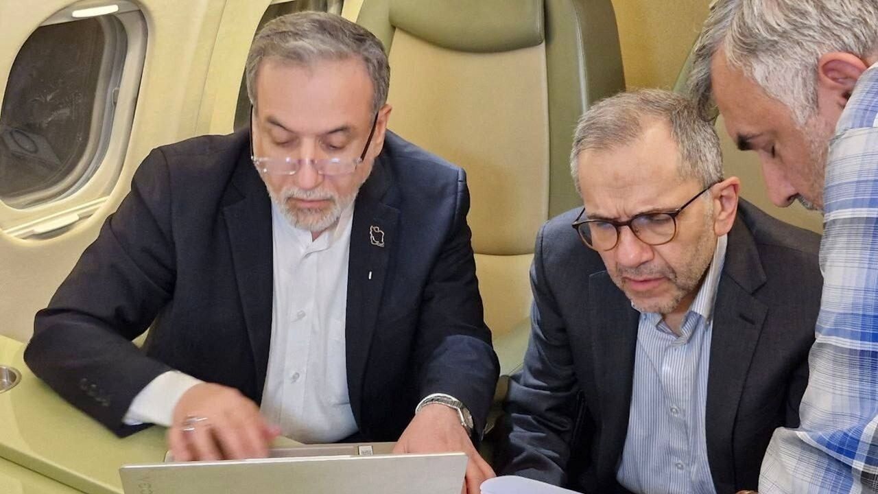 Iranian Foreign Minister Abbas Araghchi (L) and Deputy Foreign Minister for Political Affairs Majid Takht-Ravanchi on a flight to Muscat, Oman, to participate in talks with the US over Tehran's nuclear program, Feb. 5, 2026. 