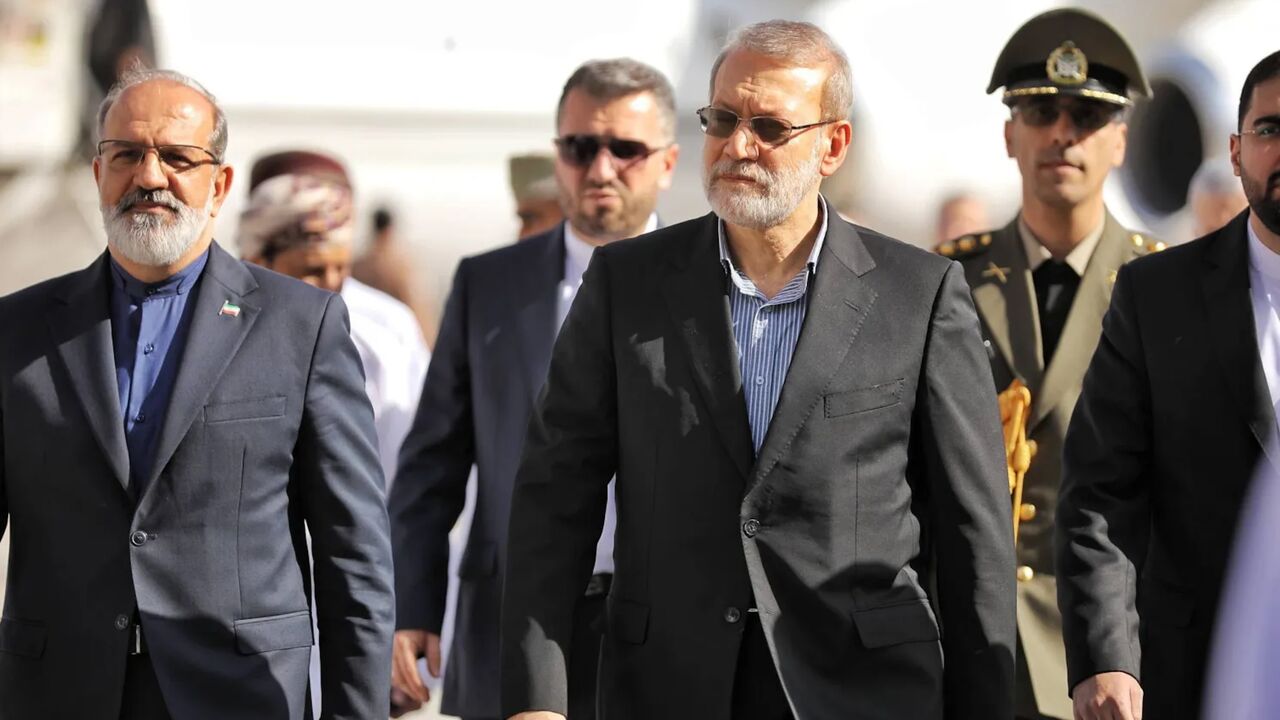 A handout photo made available by Iran's Supreme National Security Council office shows Secretary of the Supreme National Security Council Ali Larijani (C) arriving in Muscat, Oman, on Feb. 10, 2026. 