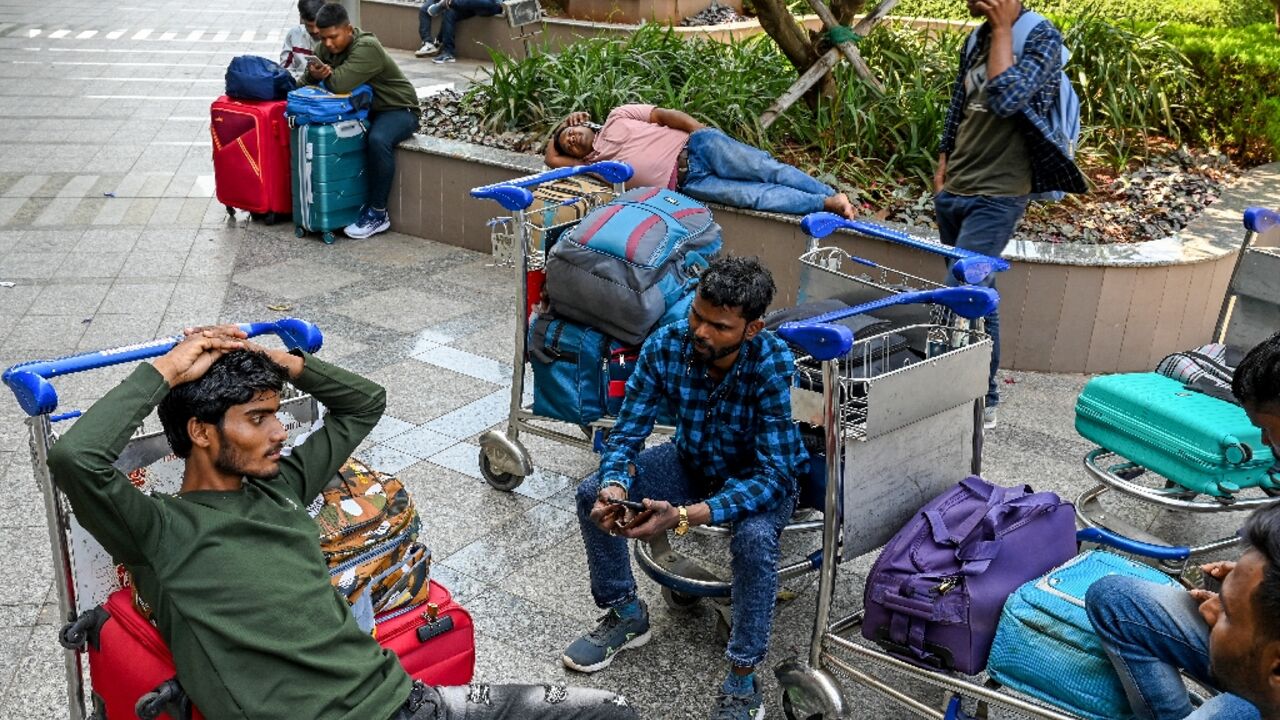 Stranded passengers wait at the departure terminal in Mumbai on March 1, 2026 after India's two largest private carriers IndiGo and Air India suspended flights to all destinations in the Middle East