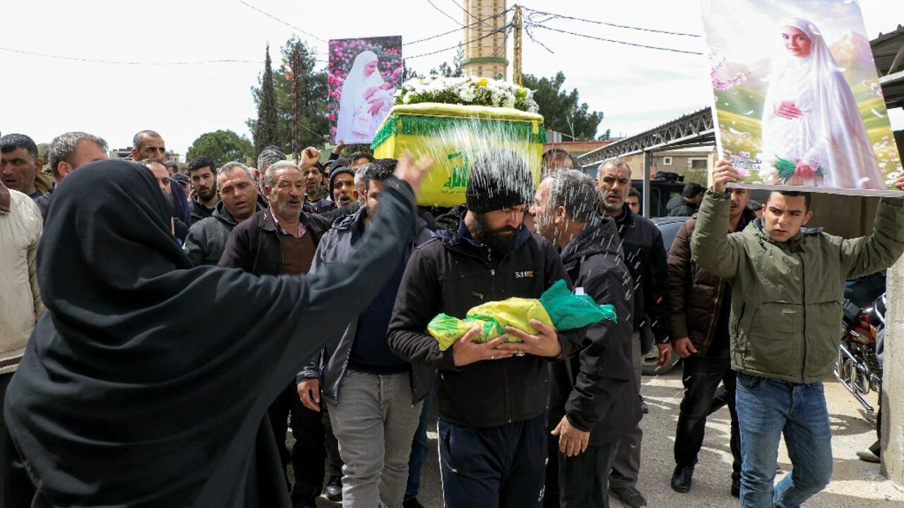 Mourners at the funeral of a woman, who was eight months pregnant with twins, killed the previous day in an airstrike on town of Bazaliyeh in Lebanon's eastern Bekaa valley
