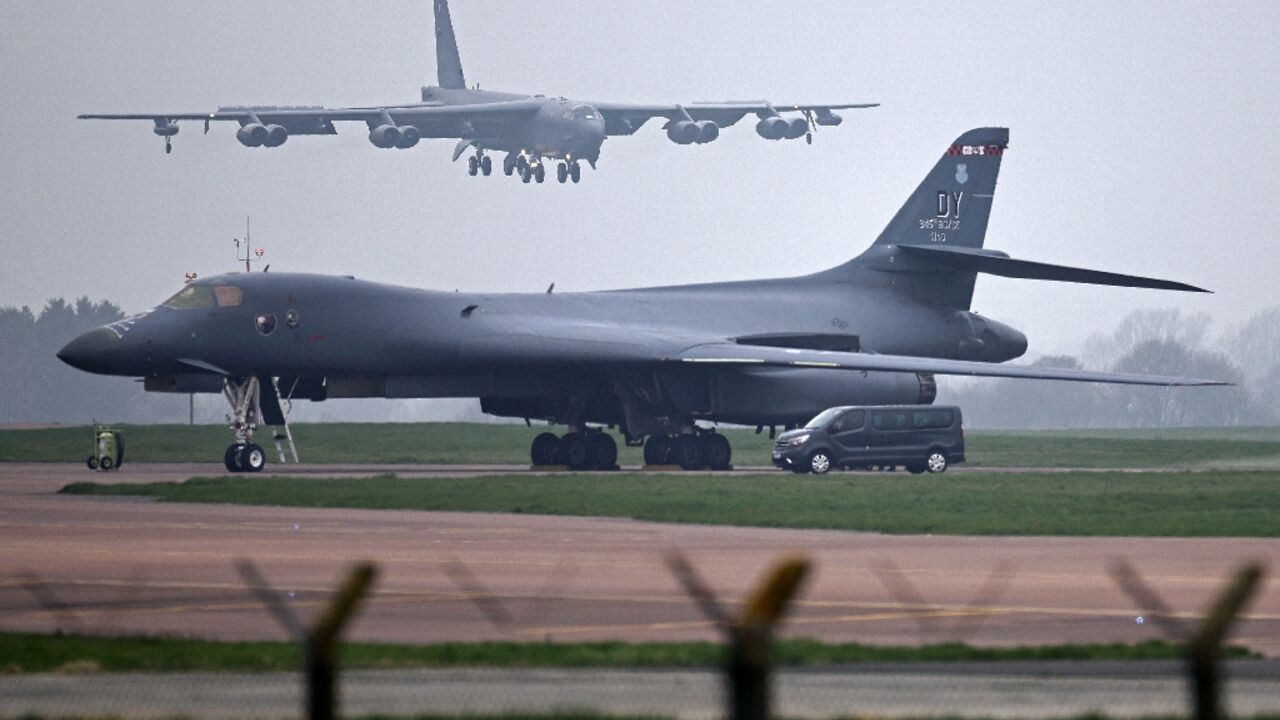 A US Air Force Boeing B-52 Stratofortress bomber jet lands on the runway, beyond a USAF Rockwell B-1 Lancer bomber jet, at RAF Fairford in south west England on March 9, 2026.