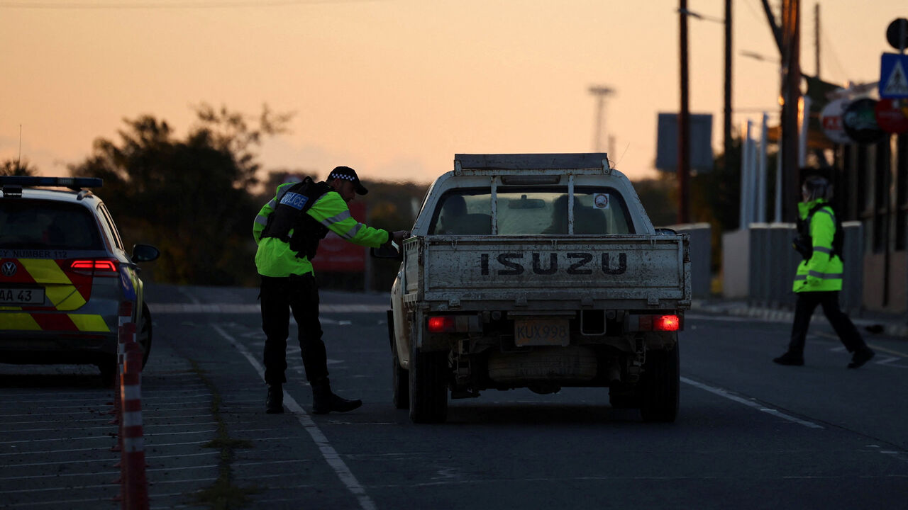 Police check vehicles on the road leading to RAF Akrotiri, a British sovereign base in Cyprus, which was hit by an unmanned drone overnight, causing limited damage, Cyprus March 2, 2026. REUTERS/Yiannis Kourtoglou
