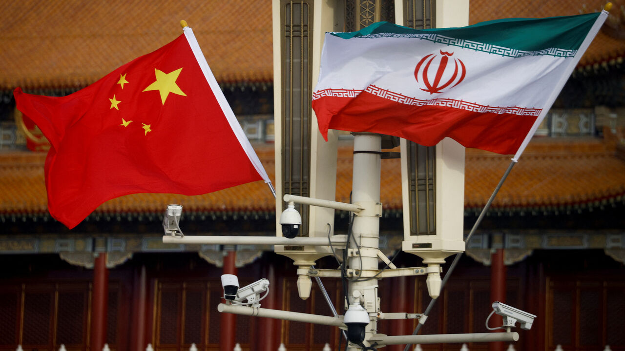 The national flags of China and Iran fly in Tiananmen Square, Beijing, China, February 14, 2023. REUTERS/Thomas Peter/File Photo