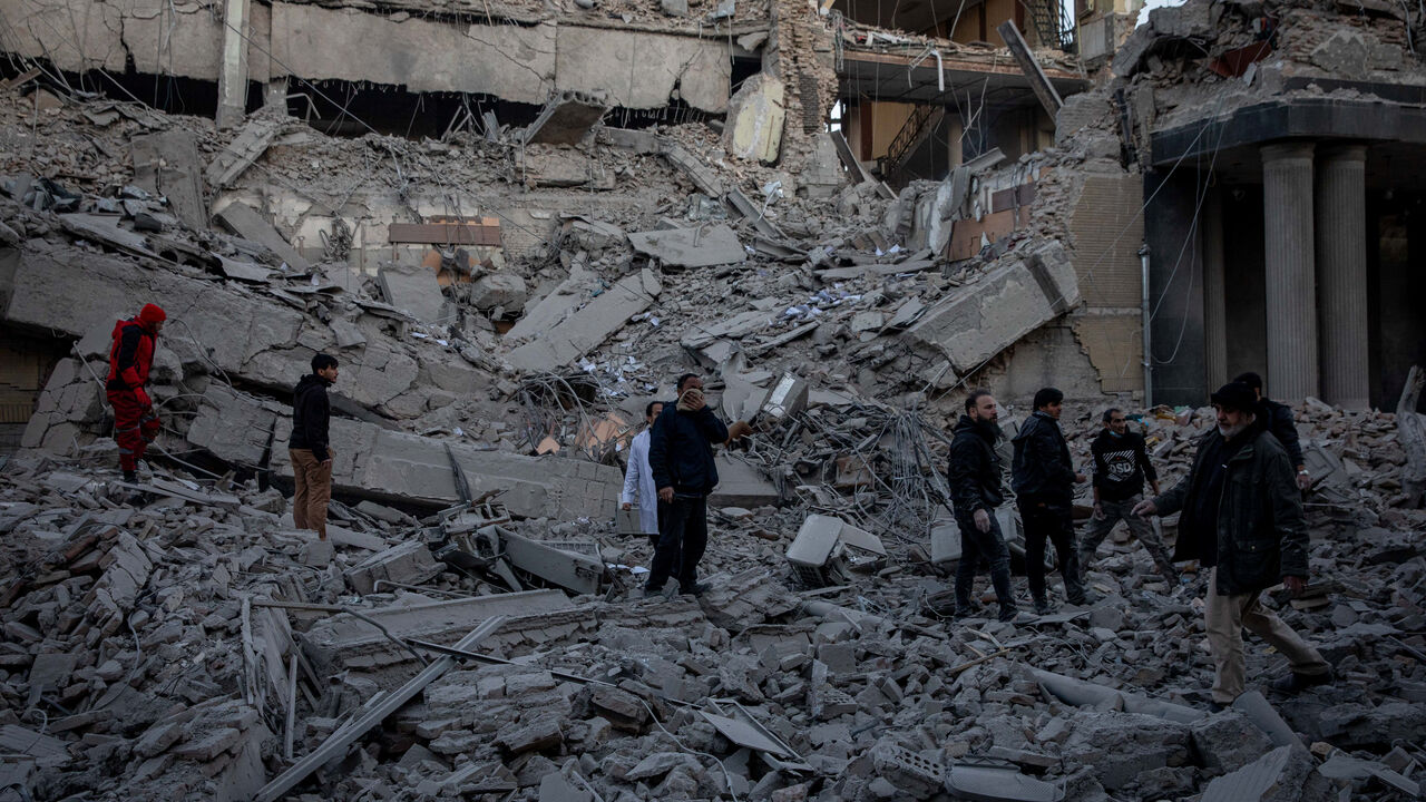 People stand in rubble at the site of an Israel and U.S. strike on a police station in Tehran, Iran, March 3, 2026. Majid Khahi/ISNA/WANA (West Asia News Agency) via REUTERS