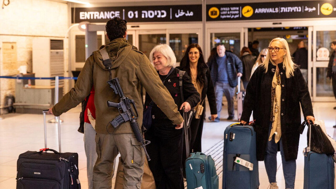 An Israeli soldier greets loved ones who returned to Israel from Italy on one of the first flights since Israel's airspace reopened, amid the U.S.-Israel conflict with Iran, at Ben Gurion International airport in Lod, Israel, March 5, 2026. Government Press Office/Handout via REUTERS