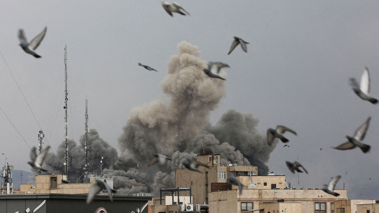 FILE PHOTO: Birds fly as smoke rises following an explosion, after Israel and the U.S. launched strikes on Iran, amid the U.S.-Israel conflict with Iran, in Tehran, Iran, March 2, 2026. WANA (West Asia News Agency) via REUTERS/File Photo