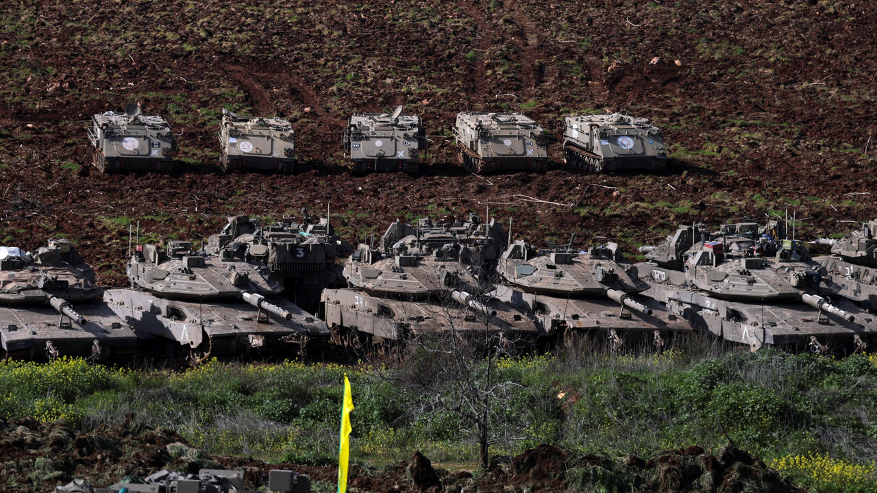 Israeli military vehicles sit on the Israeli side of the border with Lebanon, amid escalation between Hezbollah and Israel, amid the U.S.-Israeli conflict with Iran, in northern Israel, March 6, 2026. REUTERS/Ammar Awad