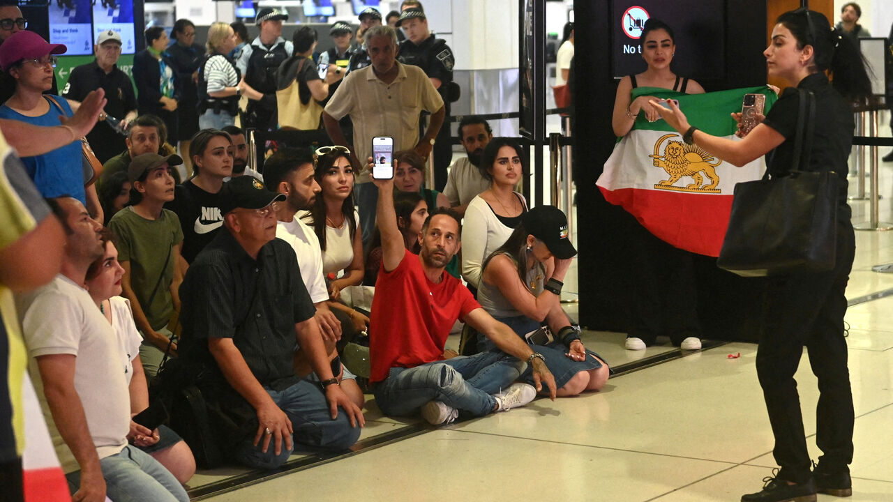 Supporters of the Iranian women's soccer team gather at Sydney Airport, after five of the players were granted asylum, in Sydney, Australia, March 10, 2026. REUTERS/Jeremy Piper