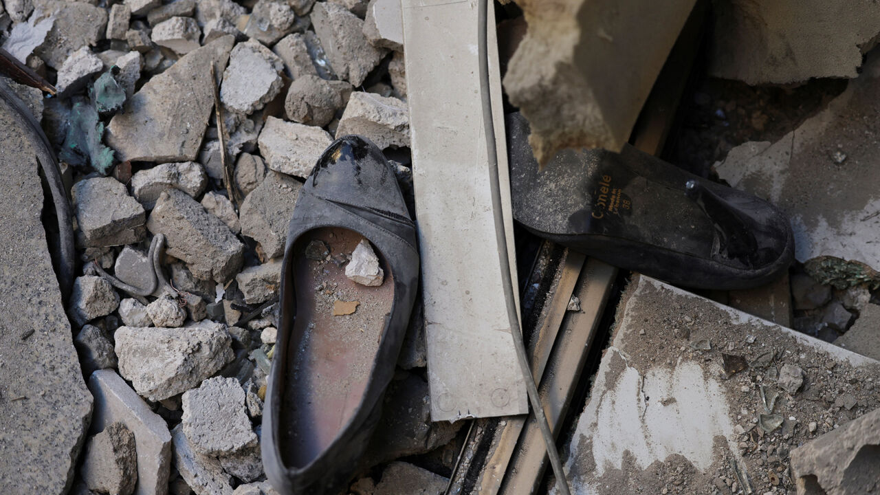 A pair of shoes lie near the site of an Israeli strike on a damaged apartment building, in central Beirut, Lebanon, March 11, 2026, following an escalation between Hezbollah and Israel amid the U.S.-Israeli conflict with Iran. REUTERS/Emilie Madi