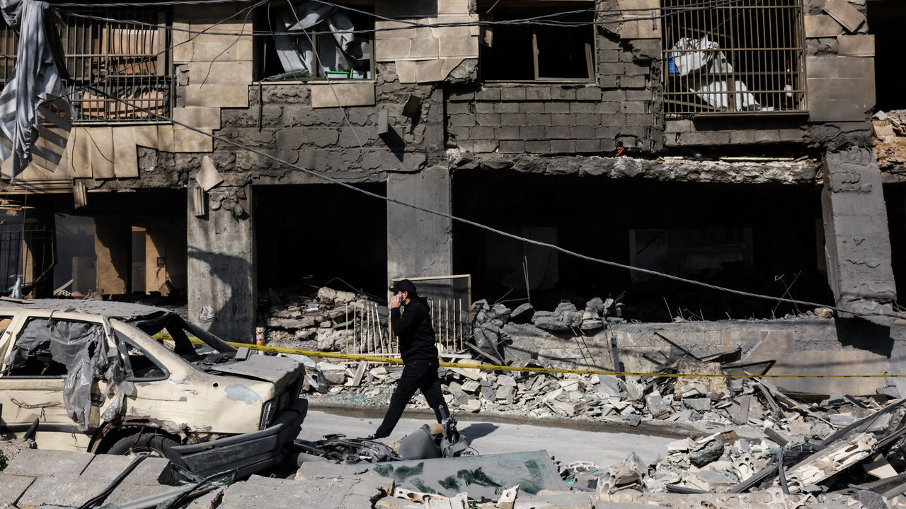 A man walks past a damaged building in the aftermath of yesterday's Israeli strikes on Bachoura neighbourhood, following an escalation between Hezbollah and Israel amid the U.S.-Israeli conflict with Iran, Lebanon, March 13, 2026. REUTERS/Mohamed Azakir