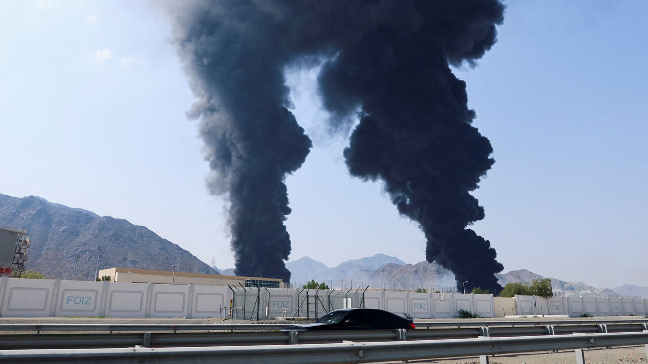 Smoke rises in the Fujairah oil industry zone, caused by debris after interception of a drone by air defenses, according to the Fujairah media office, amid the U.S.-Israel conflict with Iran, in Fujairah, United Arab Emirates, March 14, 2026. REUTERS/Staff