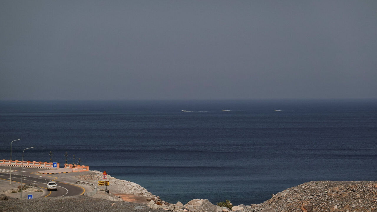 A car rides along the coast of Musandam overlooking the Strait of Hormuz amid the U.S.-Israeli conflict with Iran, Oman, March 2, 2026.REUTERS/Amr Alfiky