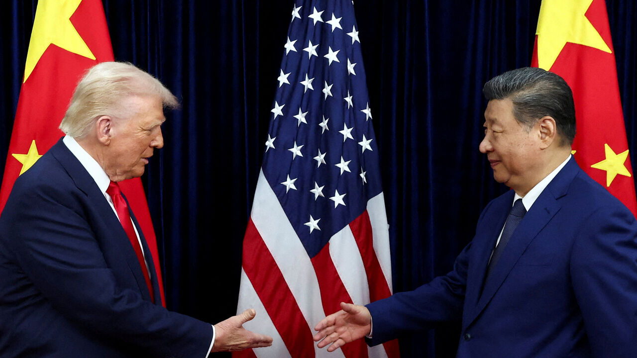 FILE PHOTO: U.S. President Donald Trump shakes hands with Chinese President Xi Jinping as they hold a bilateral meeting at Gimhae International Airport, on the sidelines of the Asia-Pacific Economic Cooperation (APEC) summit, in Busan, South Korea, October 30, 2025. REUTERS/Evelyn Hockstein/File Photo