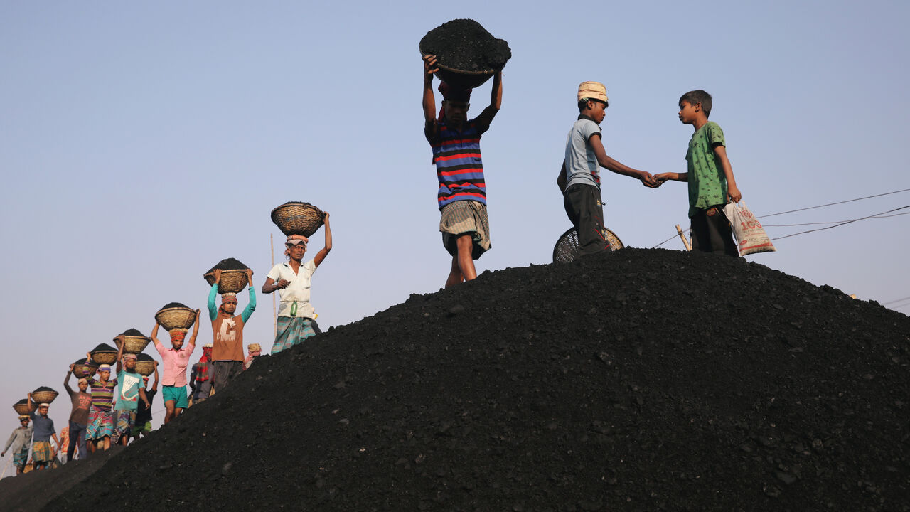 FILE PHOTO: Coal workers are seen at a market as they unload a ferry in Dhaka, Bangladesh, January 13, 2019. REUTERS/Mohammad Ponir Hossain/File Photo
