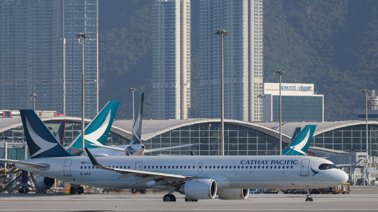 FILE PHOTO: A Cathay Pacific aircraft taxis at Hong Kong International Airport on the day of the official launch of its third runway, in Hong Kong, China November 28, 2024. REUTERS/Tyrone Siu/File Photo