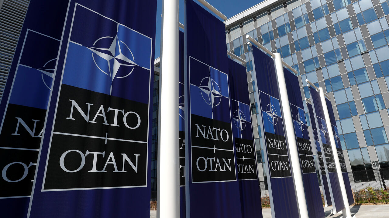 Banners displaying the NATO logo are placed at the entrance of new NATO headquarters during the move to the new building, in Brussels, Belgium April 19, 2018.  REUTERS/Yves Herman