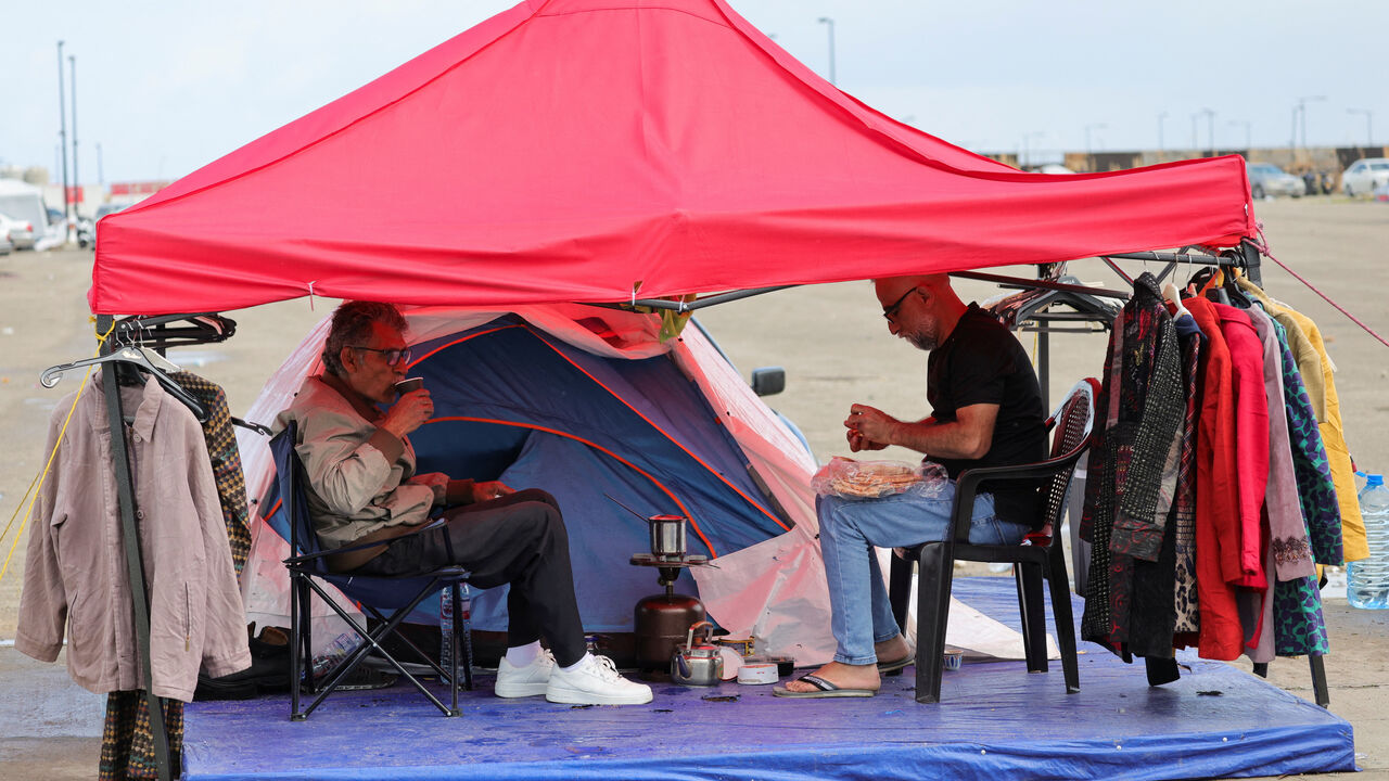 Abu Ali, displaced from the southern Lebanese town of Nabatieh, drinks coffee under a tent, as he opens a stand to collect donations to provide to displaced people where they shelter, on the day Muslim worshippers attend Eid al-Fitr prayers to mark the end of the holy fasting month of Ramadan, following an escalation between Hezbollah and Israel amid the U.S.-Israeli conflict with Iran, in Beirut, Lebanon, March 20, 2026. REUTERS/Yara Nardi