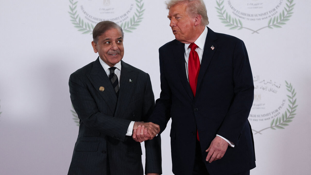 U.S. President Donald Trump and Pakistani Prime Minister Shehbaz Sharif shake hands as they pose for a photo, at a world leaders' summit on ending the Gaza war, amid a U.S.-brokered prisoner-hostage swap and ceasefire deal between Israel and Hamas, in Sharm el-Sheikh, Egypt, October 13, 2025. REUTERS/Suzanne Plunkett/Pool