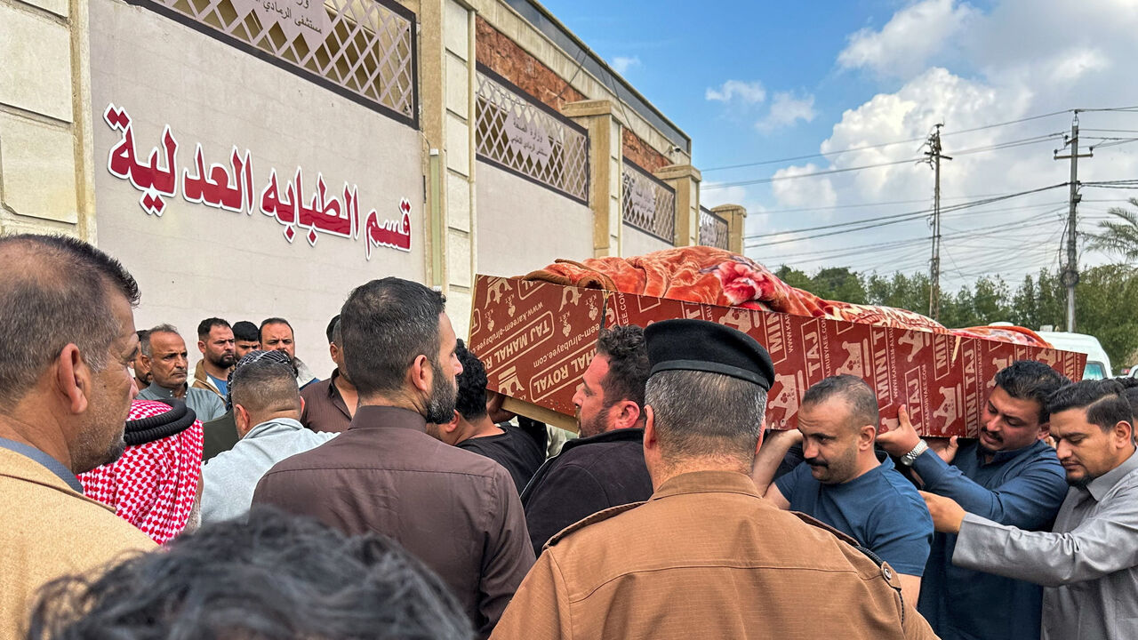 Relatives carry the coffin of an Iraqi soldier killed in an airstrike near an army medical centre in western Anbar, at the forensic medicine department of Ramadi General Hospital, Iraq March 25, 2026. REUTERS/Osama Al-Dulaimi