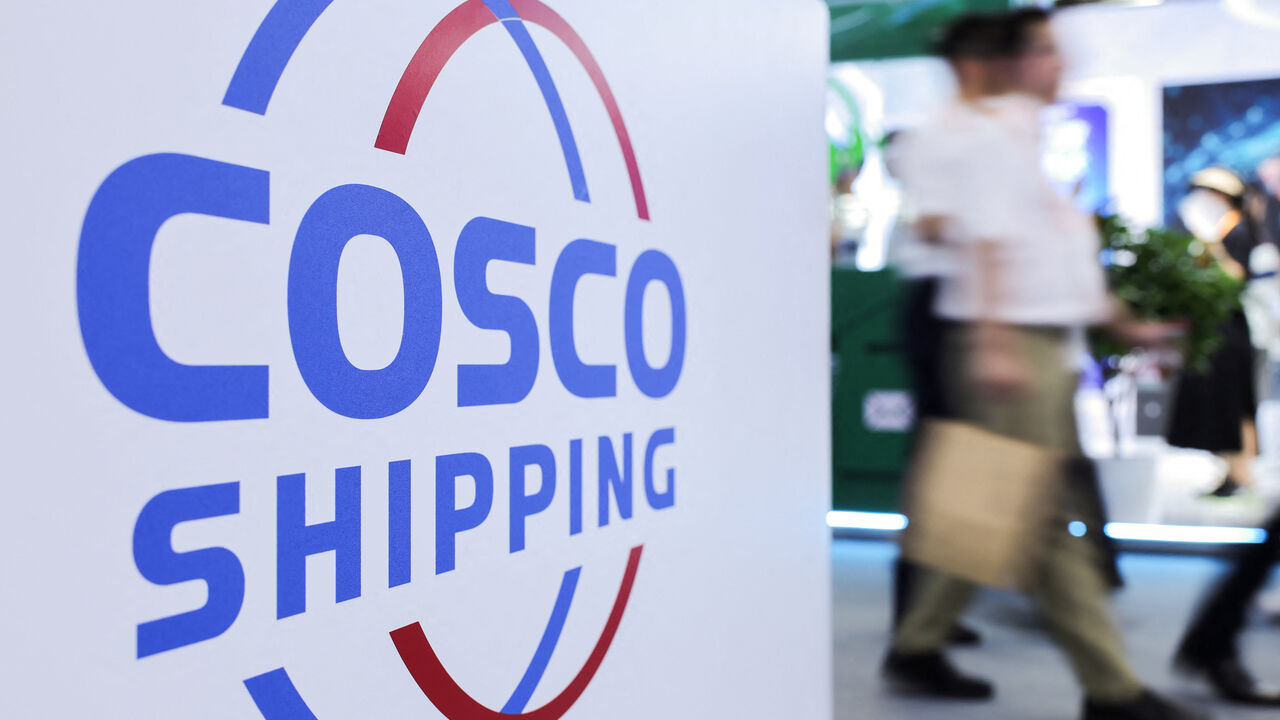 FILE PHOTO: People walk next to a logo of China Ocean Shipping Company (COSCO) at the China International Fair for Trade in Services (CIFTIS) in Beijing, China, September 11, 2025. REUTERS/Maxim Shemetov/File Photo