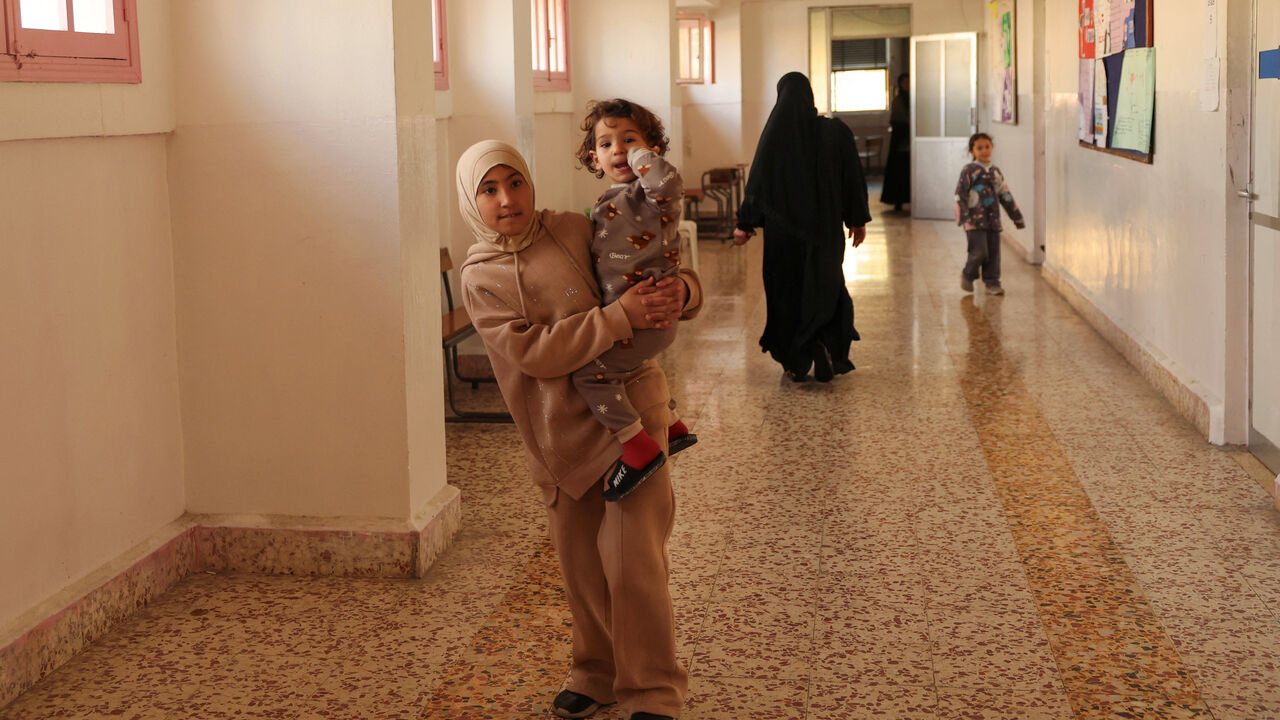 Displaced children walk at the Jaafareya High School, now used as a temporary shelter for displaced people, amid escalating hostilities between Israel and Hezbollah, as the U.S.-Israel conflict with Iran continues, in Beirut, Lebanon, March 27, 2026. REUTERS/Yara Nardi