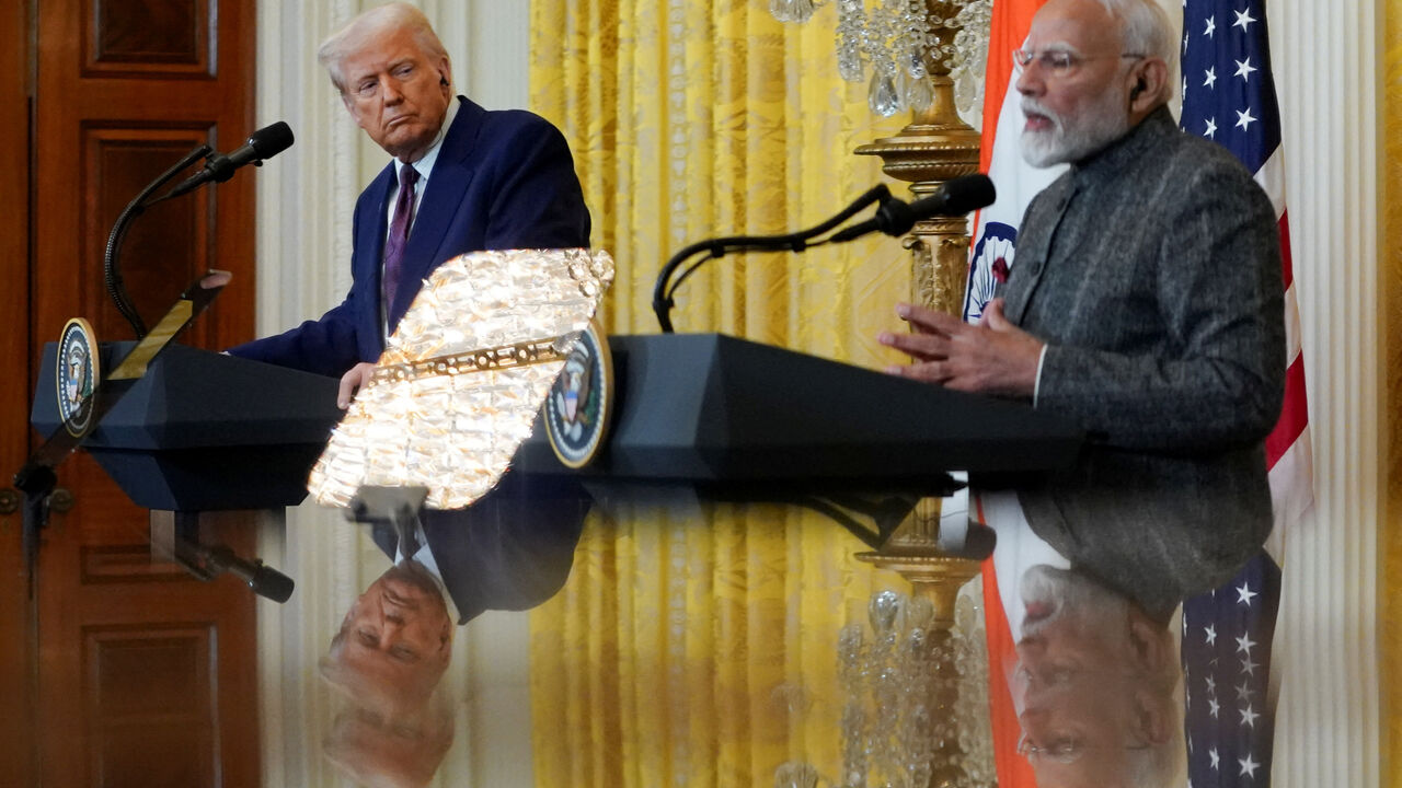 FILE PHOTO: U.S. President Donald Trump and Indian Prime Minister Narendra Modi are pictured in a mirror as they attend a joint press conference at the White House in Washington, D.C., U.S., February 13, 2025. REUTERS/Nathan Howard/File Photo