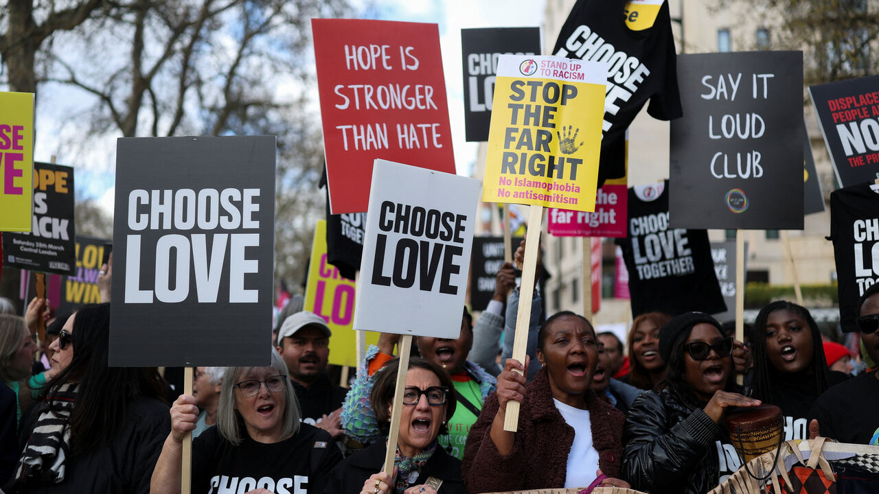 Demonstrators carry placards as they gather prior to a march against far-right extremism from Park Lane to Trafalgar Square, organised by the Together Alliance, a coalition of unions and civil society groups, in London, Britain, March 28, 2026. REUTERS/Hannah McKay
