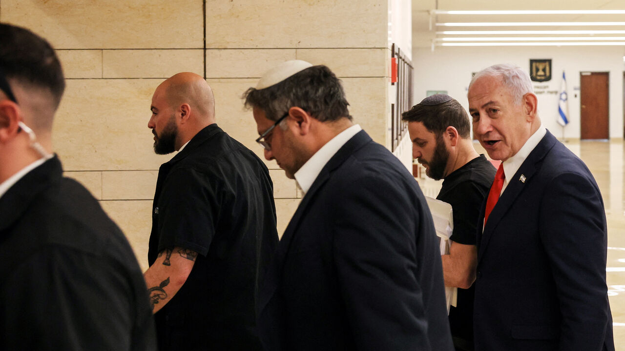 Israeli Prime Minister Benjamin Netanyahu and National Security Minister Itamar Ben-Gvir walk together inside the Knesset in Jerusalem March 27, 2025. REUTERS/Ronen Zvulun